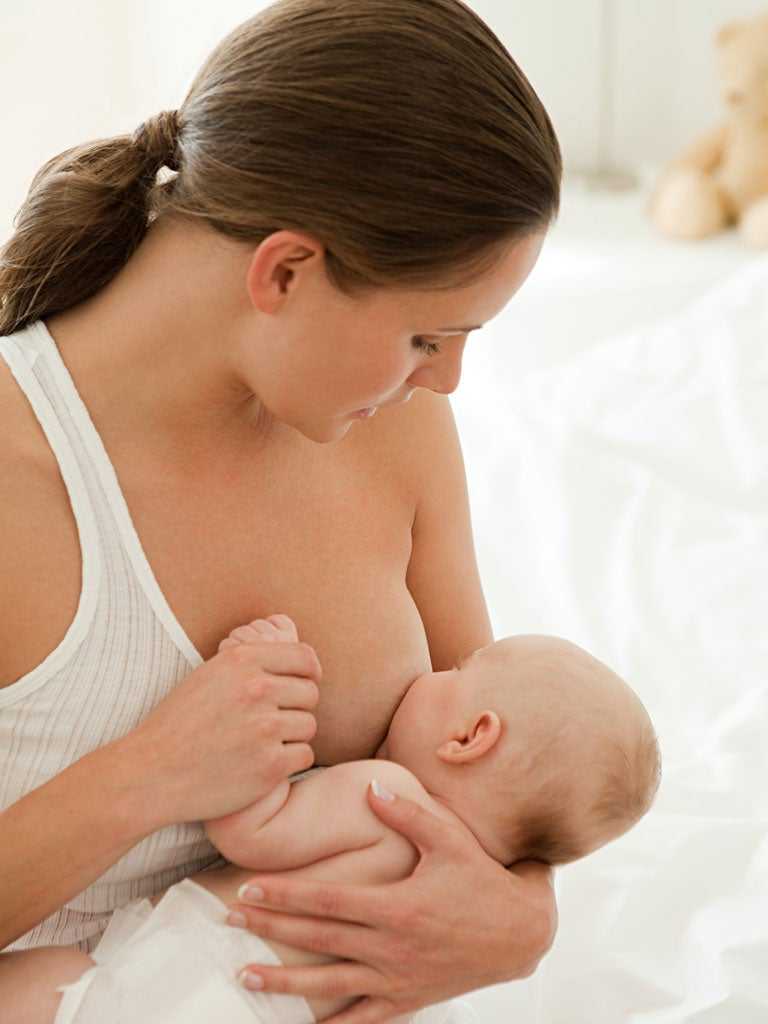 Baby holding ear while feeding