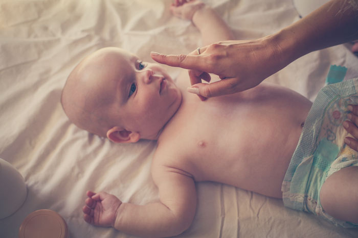 Feeding baby while lying on back