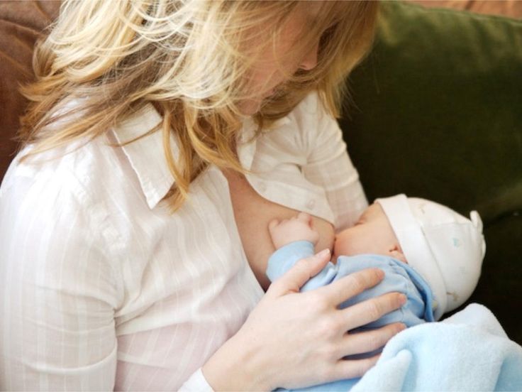 Baby feeding milk from breast