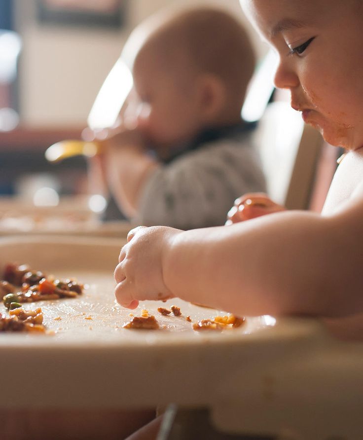 Babies eating solid food