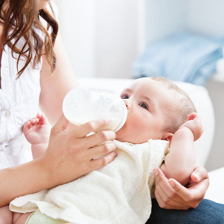 Mother bottle feeding baby