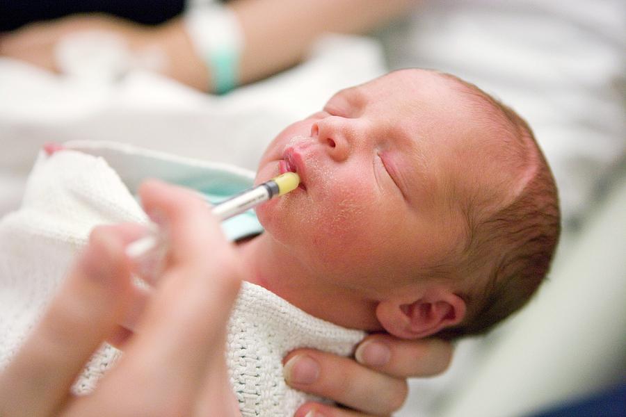 Feeding honey to newborn baby