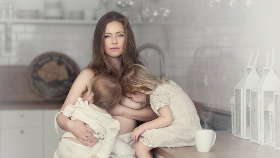 Beautiful girl feeding baby