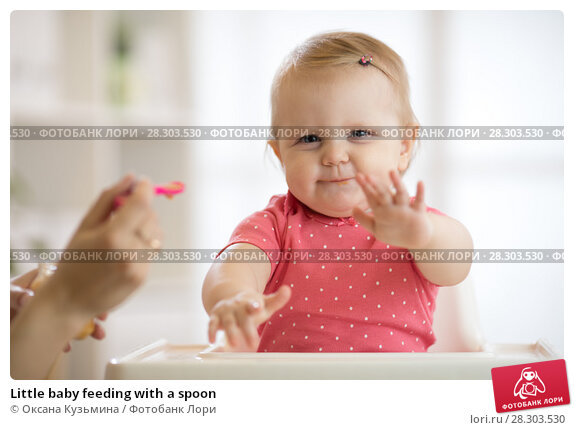 At what age do babies feed themselves with a spoon